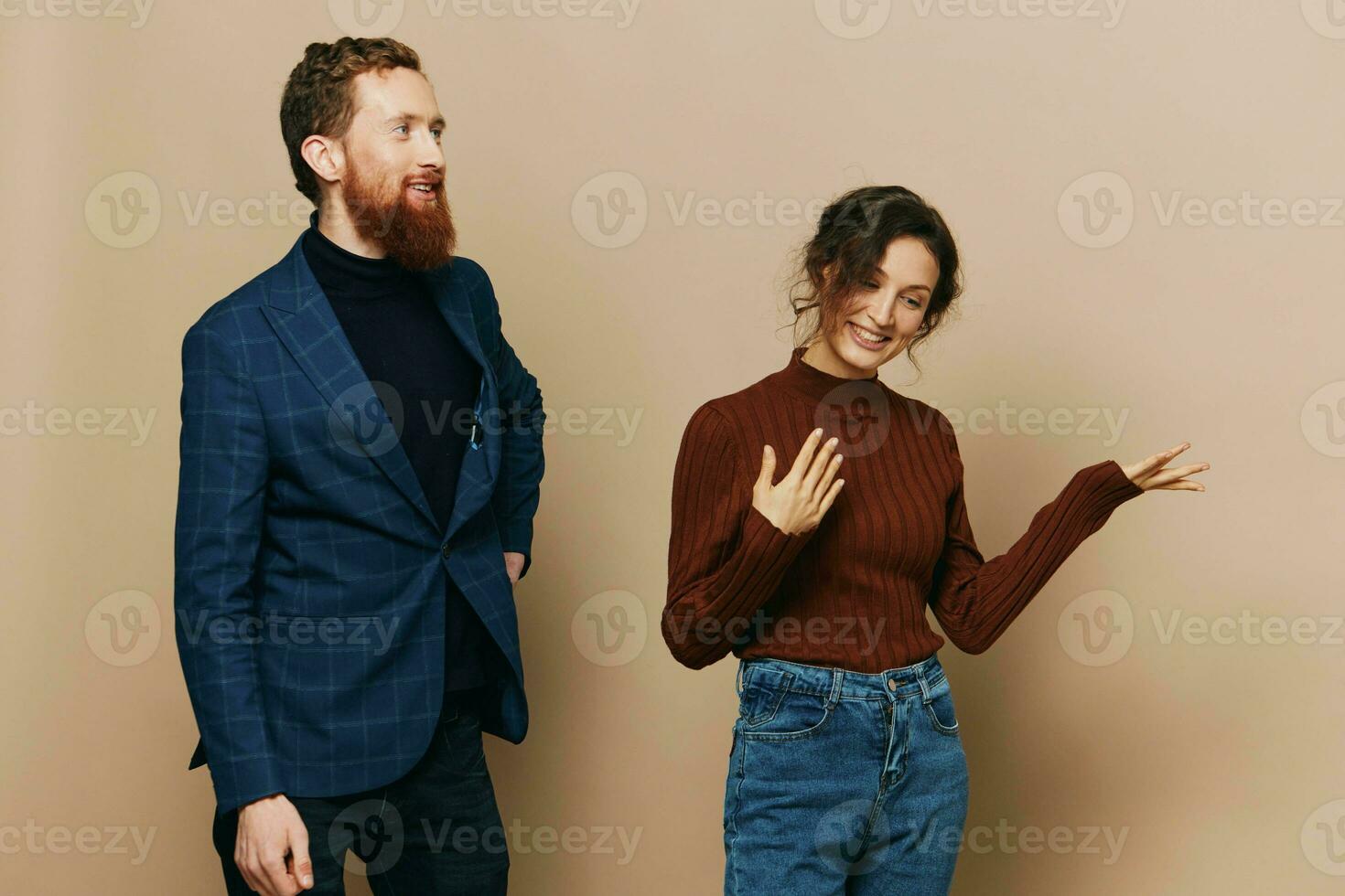 Man and woman couple in a relationship smile and interaction on a beige background in a real relationship between people photo