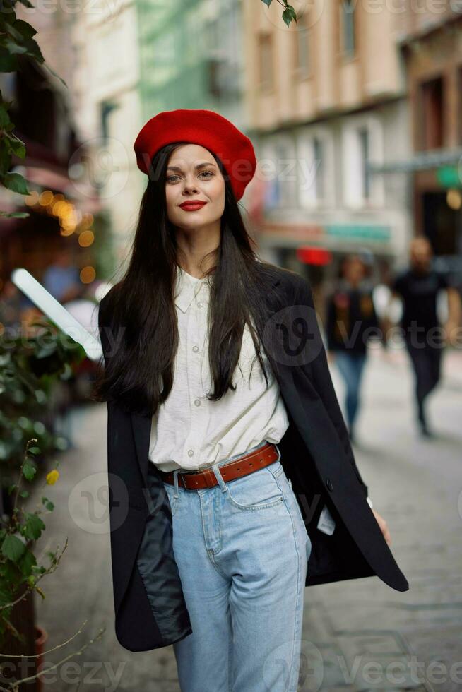 Woman smile fashion model walks on the street in the city center among the crowd in a jacket and red beret and jeans, cinematic french fashion style clothing, travel to istanbul spring photo