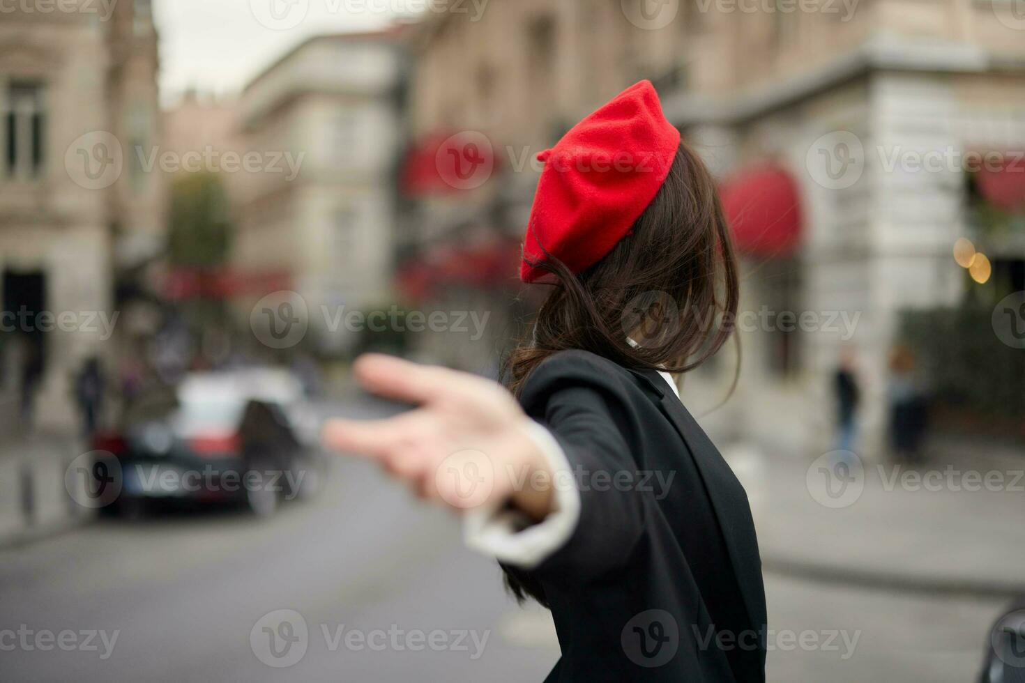 Fashion woman smile with teeth standing on the street in front of the city tourist follow me stylish clothes with red lips and red beret, travel, cinematic color, retro vintage style, urban fashion. photo