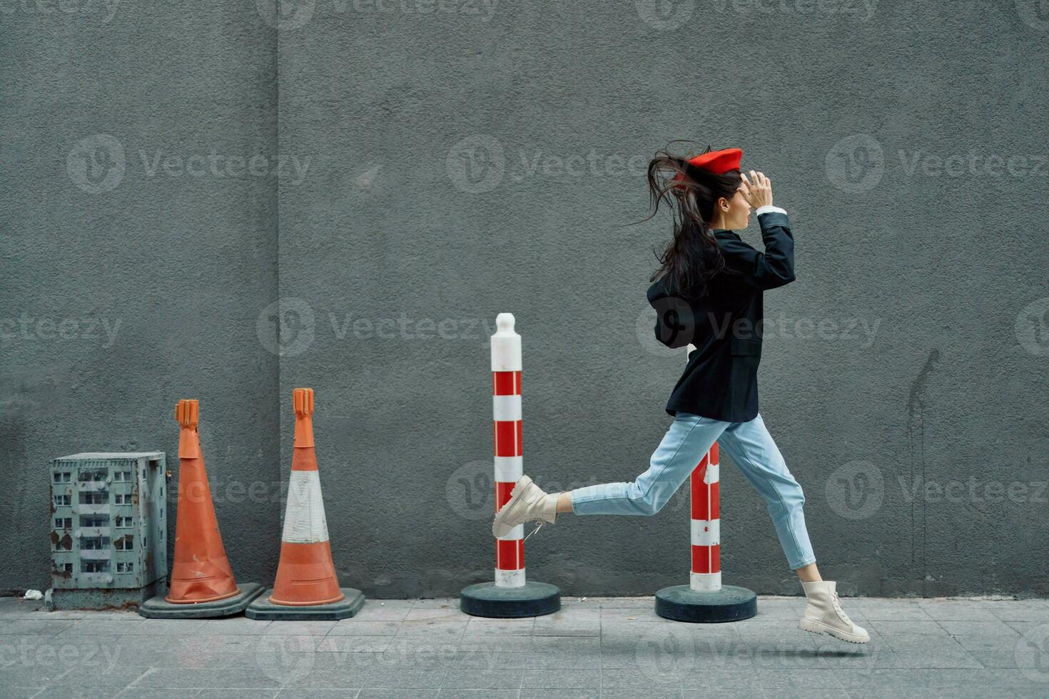 Moda mujer corriendo abajo el calle en frente de el ciudad turista en elegante ropa con rojo labios y rojo boina, viajar, cinematográfico color, retro Clásico estilo, tarde a trabajar. foto
