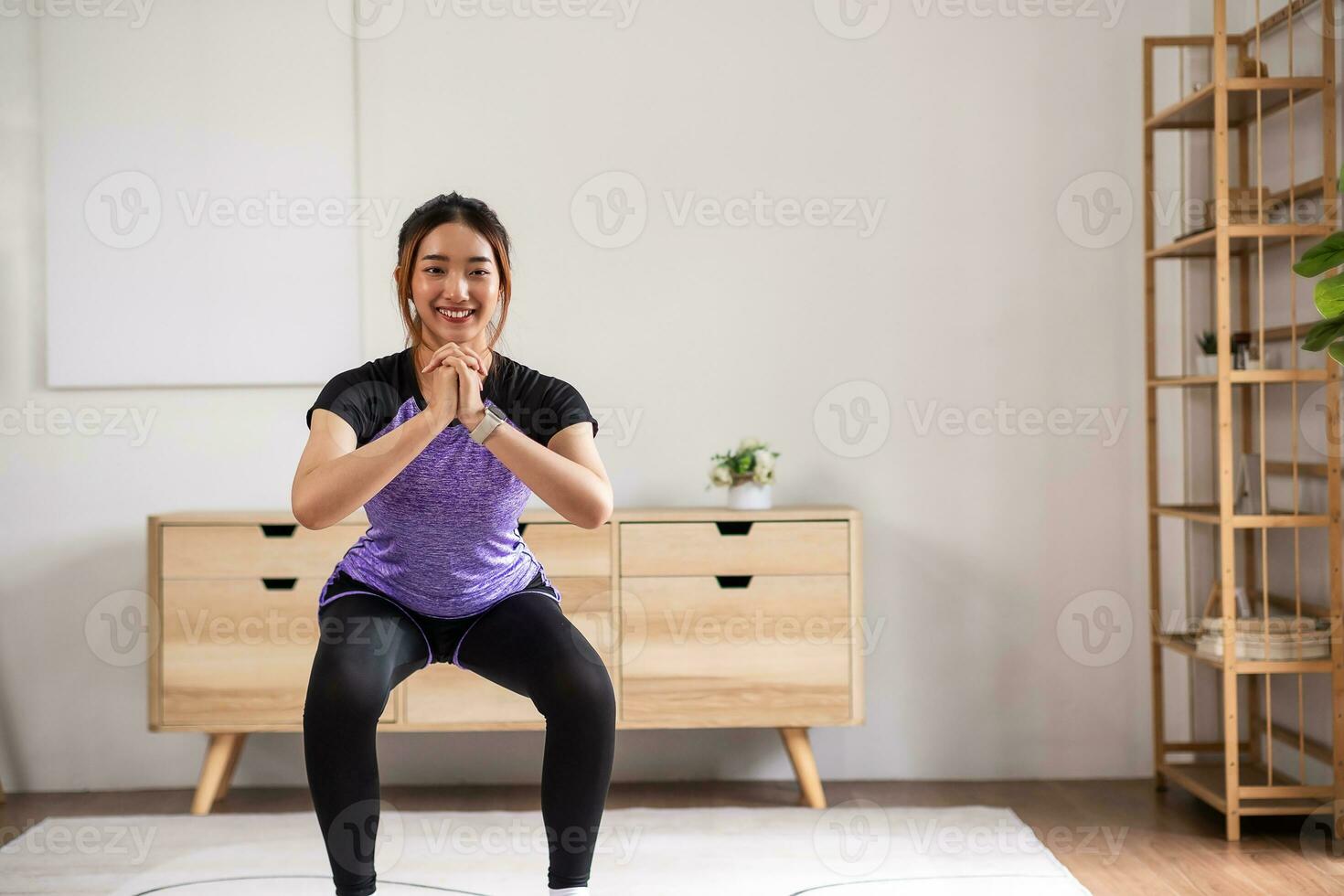 Asian women is doing forward lunge exercises at home photo