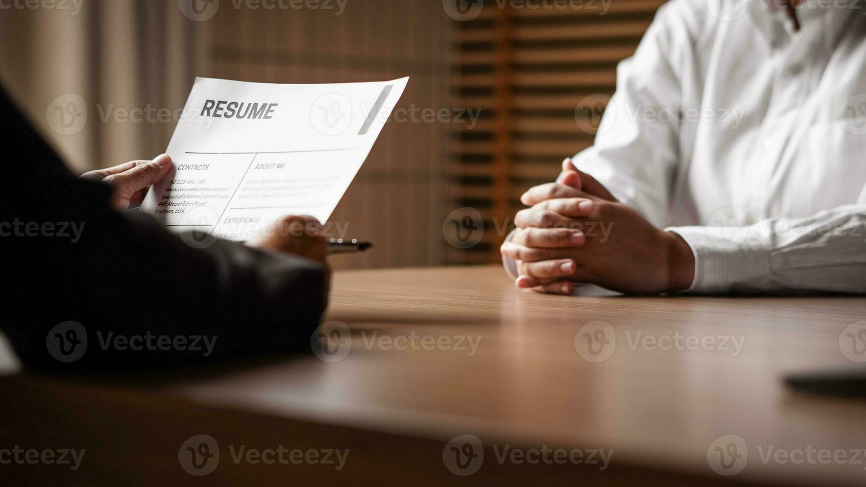 Image of employer or recruiter holding reading a resume during about colloquy his profile of candidate. photo