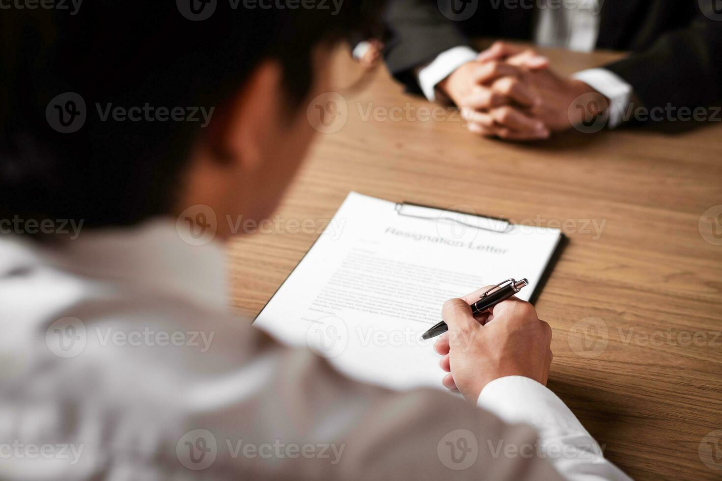 Image of employer or recruiter holding reading a resume during about colloquy his profile of candidate. photo