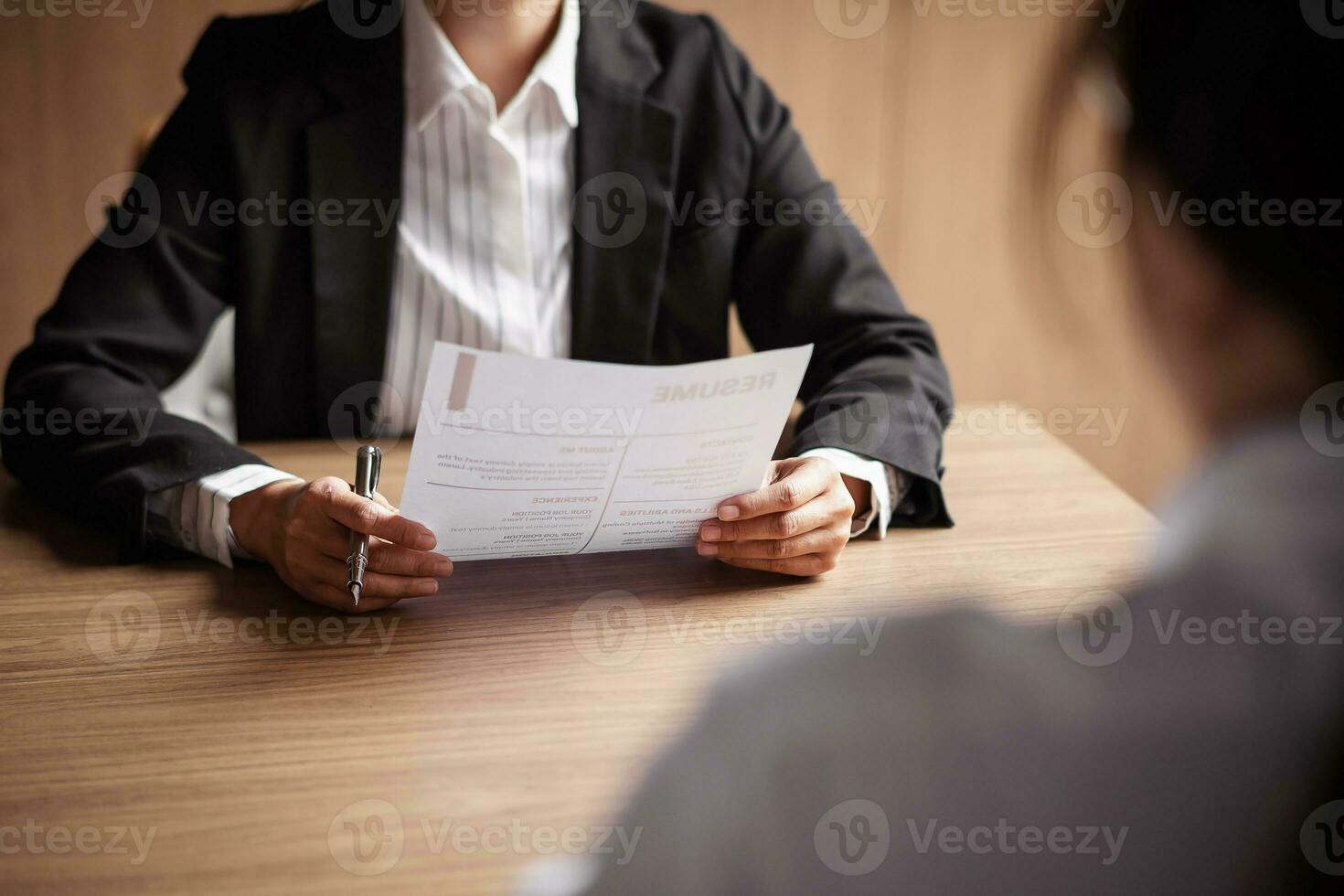 Image of employer or recruiter holding reading a resume during about colloquy his profile of candidate. photo
