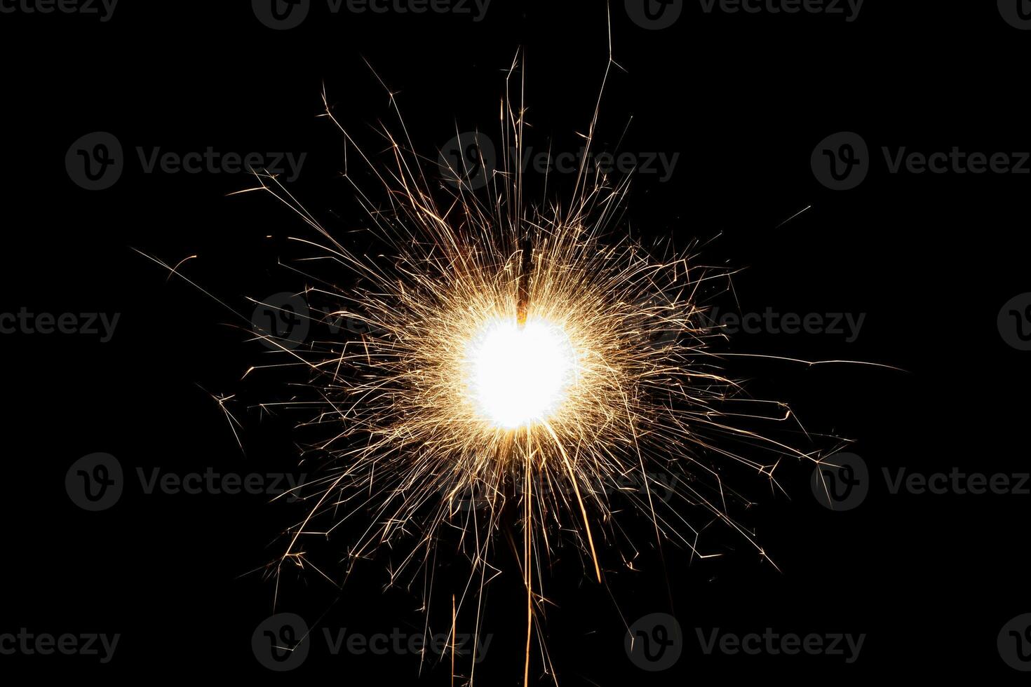 Burning sparkler isolated on black background. Fireworks theme. Light effect and texture. photo