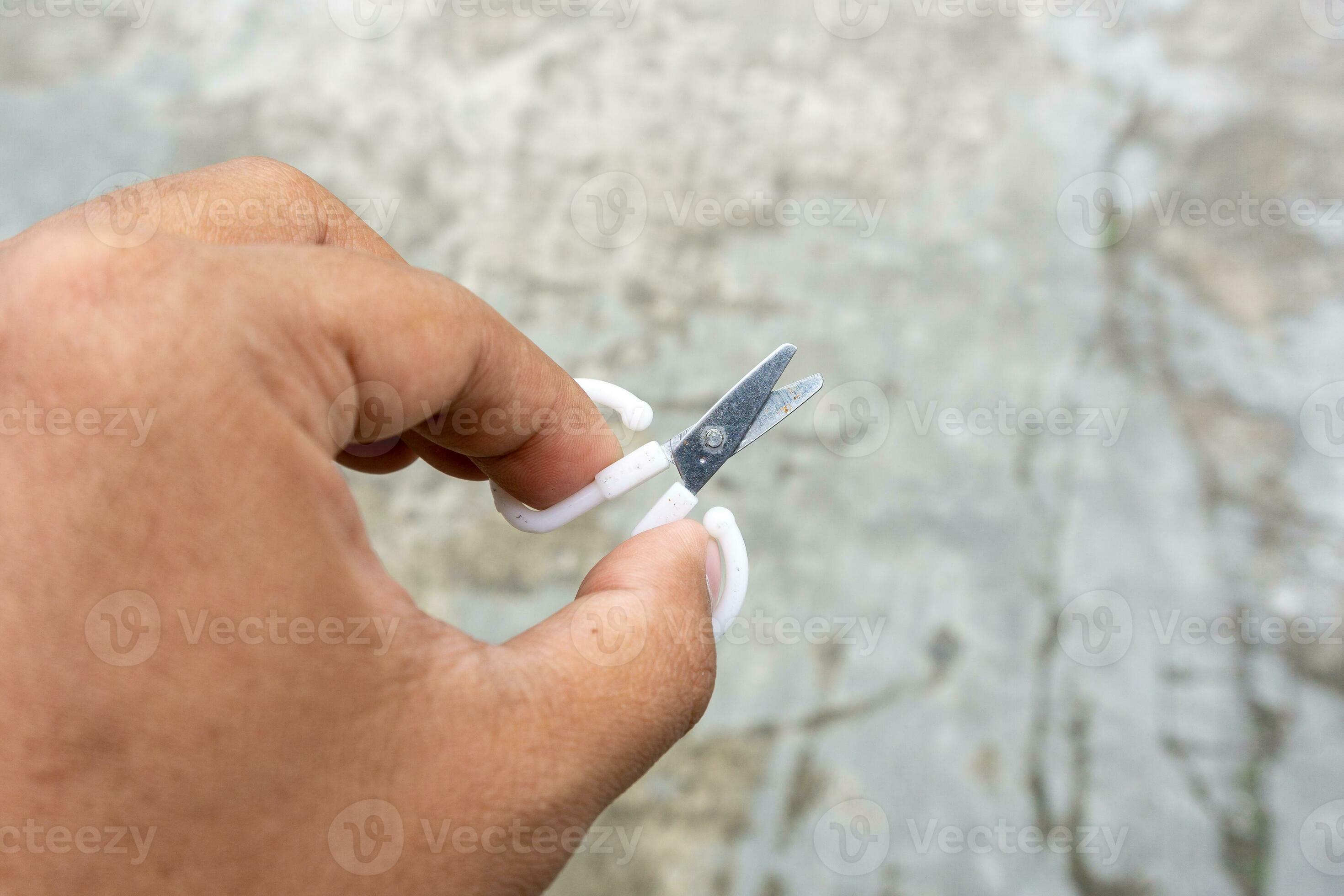 cute little scissors for kids playing. Small scissors on adult hand