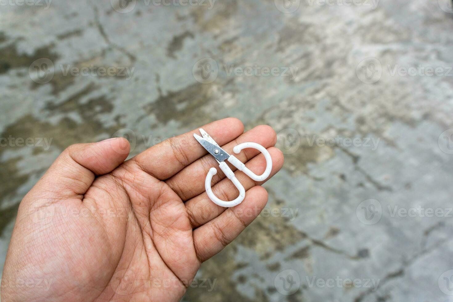 cute little scissors for kids playing. Small scissors on adult hand