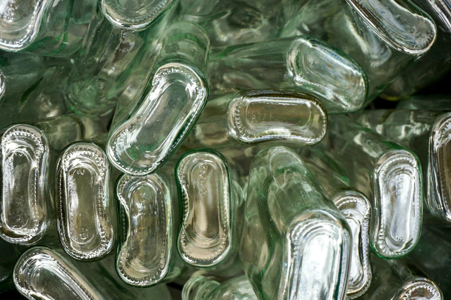 Closeup and crop bottom of flat glass bottle in full screen background photo