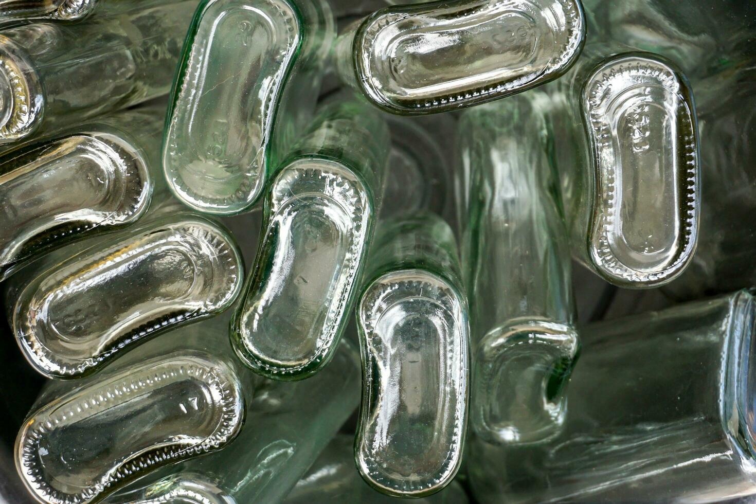 Closeup and crop bottom of flat glass bottle in full screen background photo