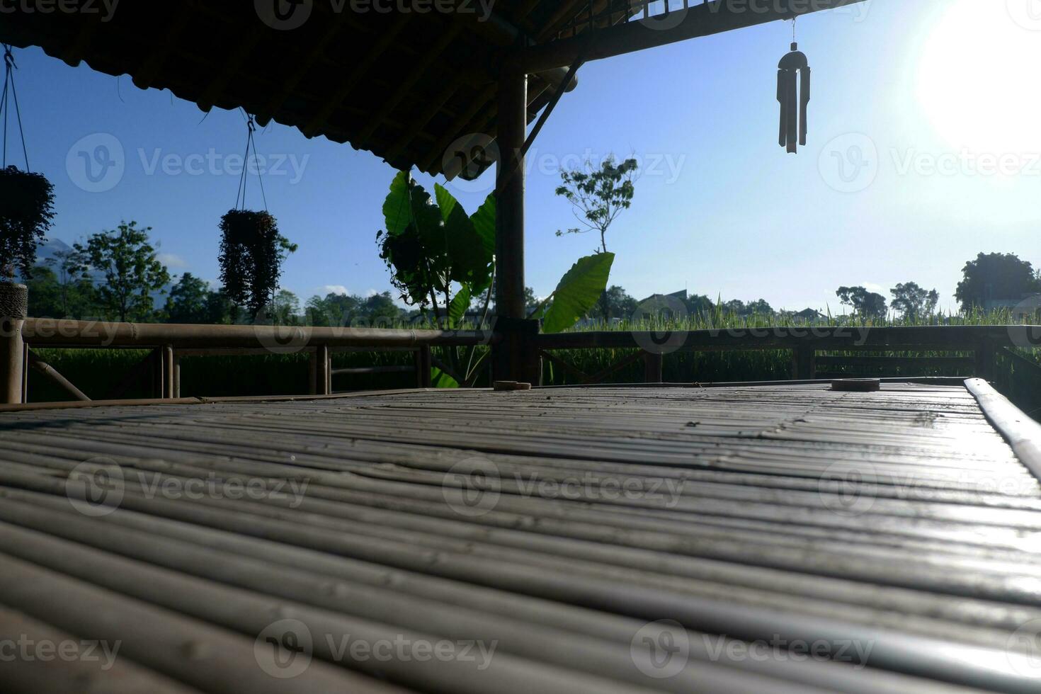 Bamboo Bells in a Hut With Views of Green and Beautiful Rice Fields and Beautiful Highlights of Morning Sunlight. photo