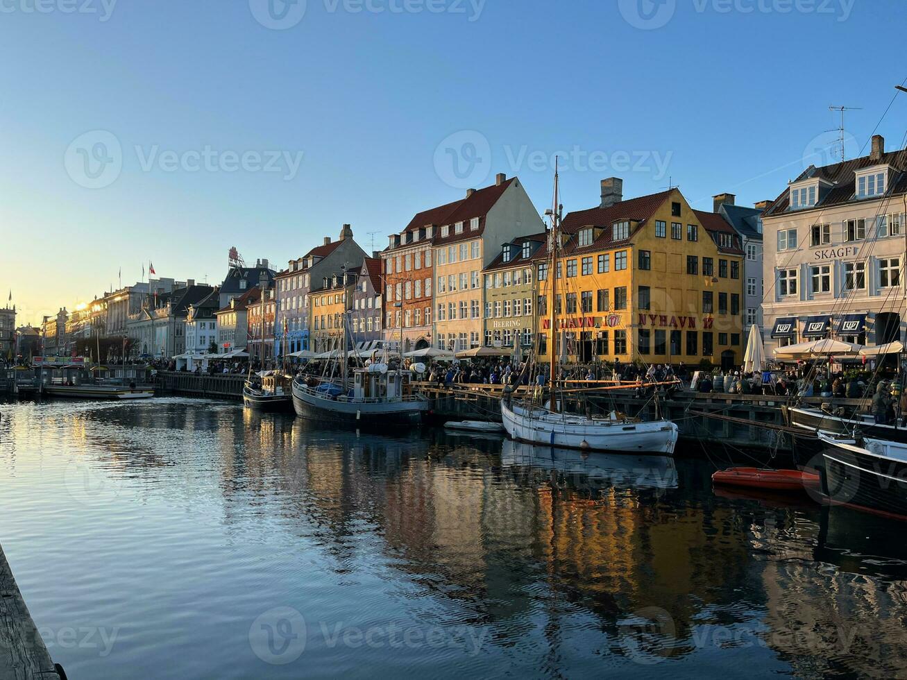 Nyhavn at sunset with colorful houses and boats photo