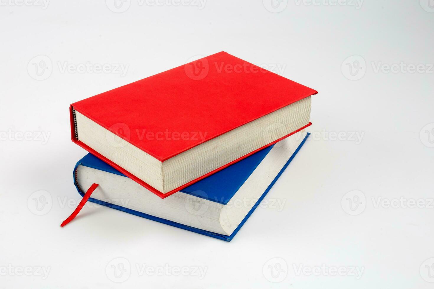 closed red and blue books on a reflecting white background photo