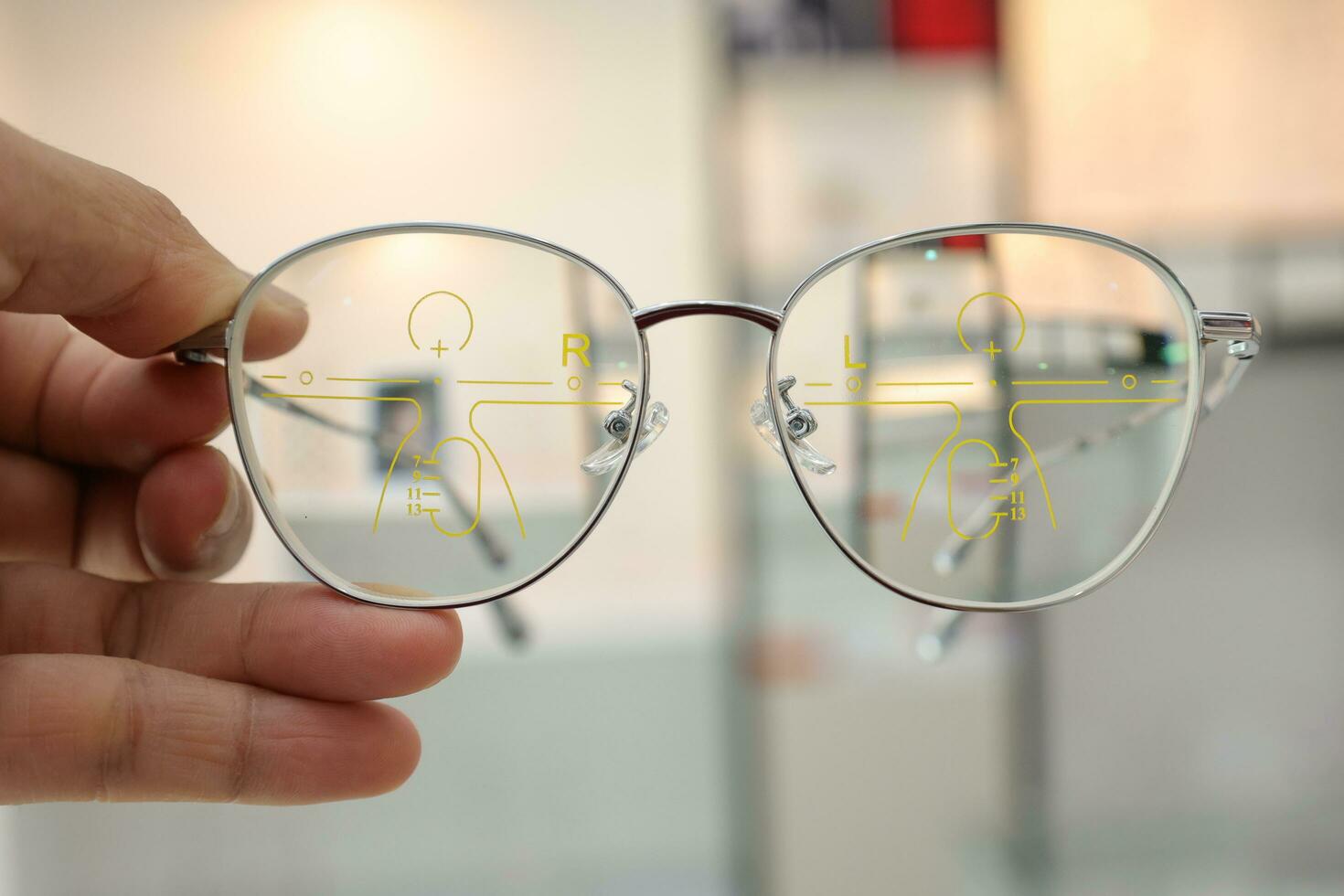 Hand holding glasses on blur background photo