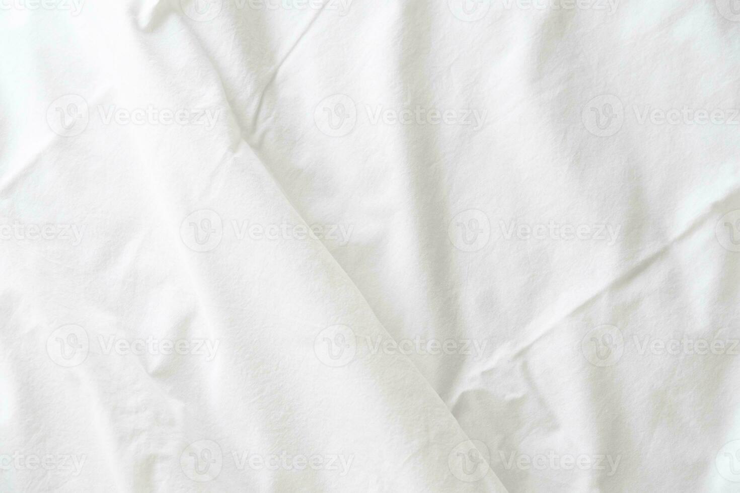 Abstract pattern of white crumpled bed sheet. White wrinkled fabric