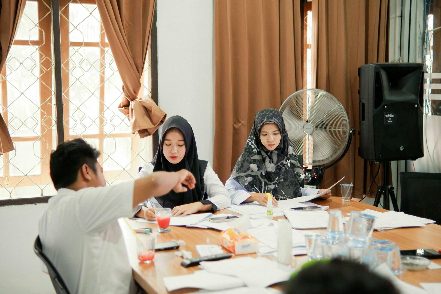 Kuaro Kalimantan timur, Indonesia 6 July 2023. some people are working on making documents in the office photo
