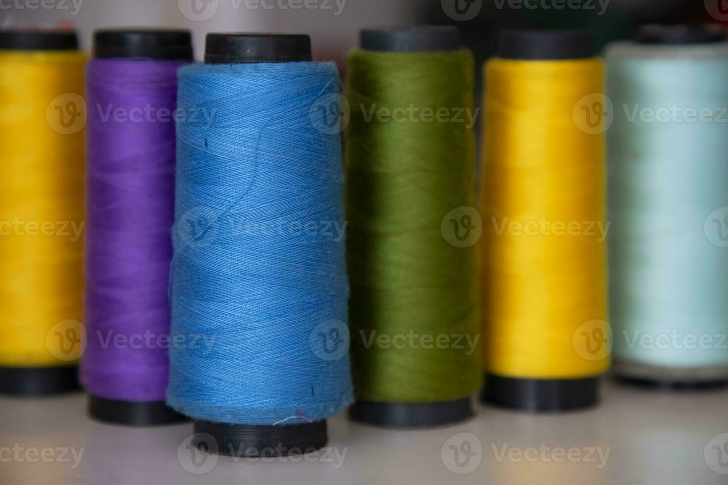 Some multicolor Spools of  swings thread Close-up Focus photo
