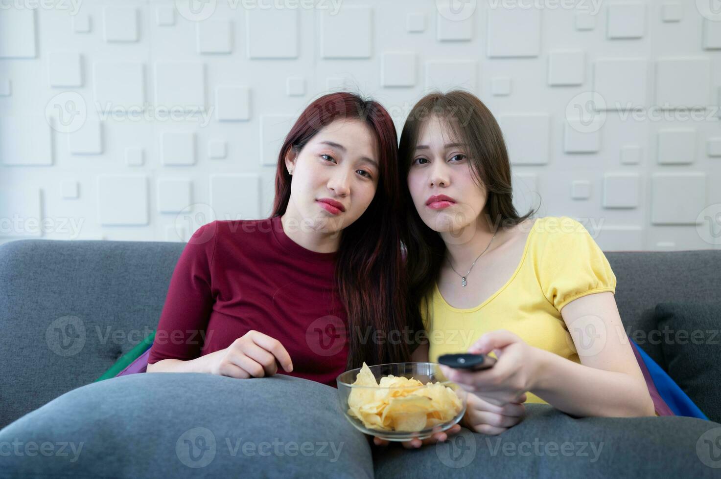 The LGBT couple is watching a sad drama. They were crying along with the drama on the sofa in the living room of the house. photo