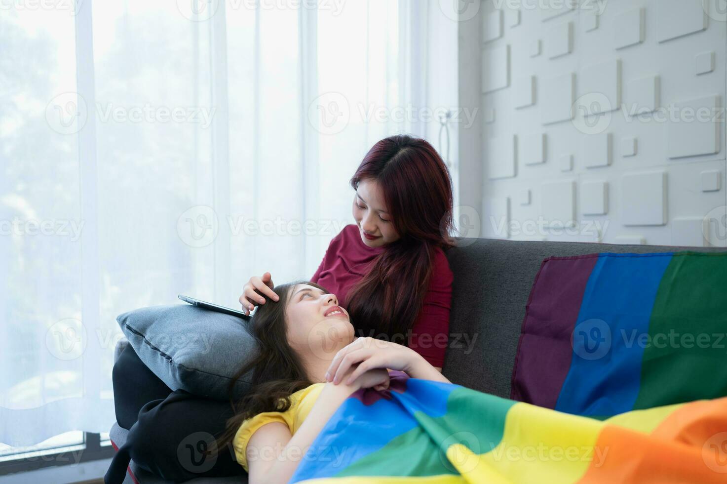 The LGBT couple with vacation activities at home such as teasing, talking, watching movies, listening to music, eating snacks in a happy mood. photo