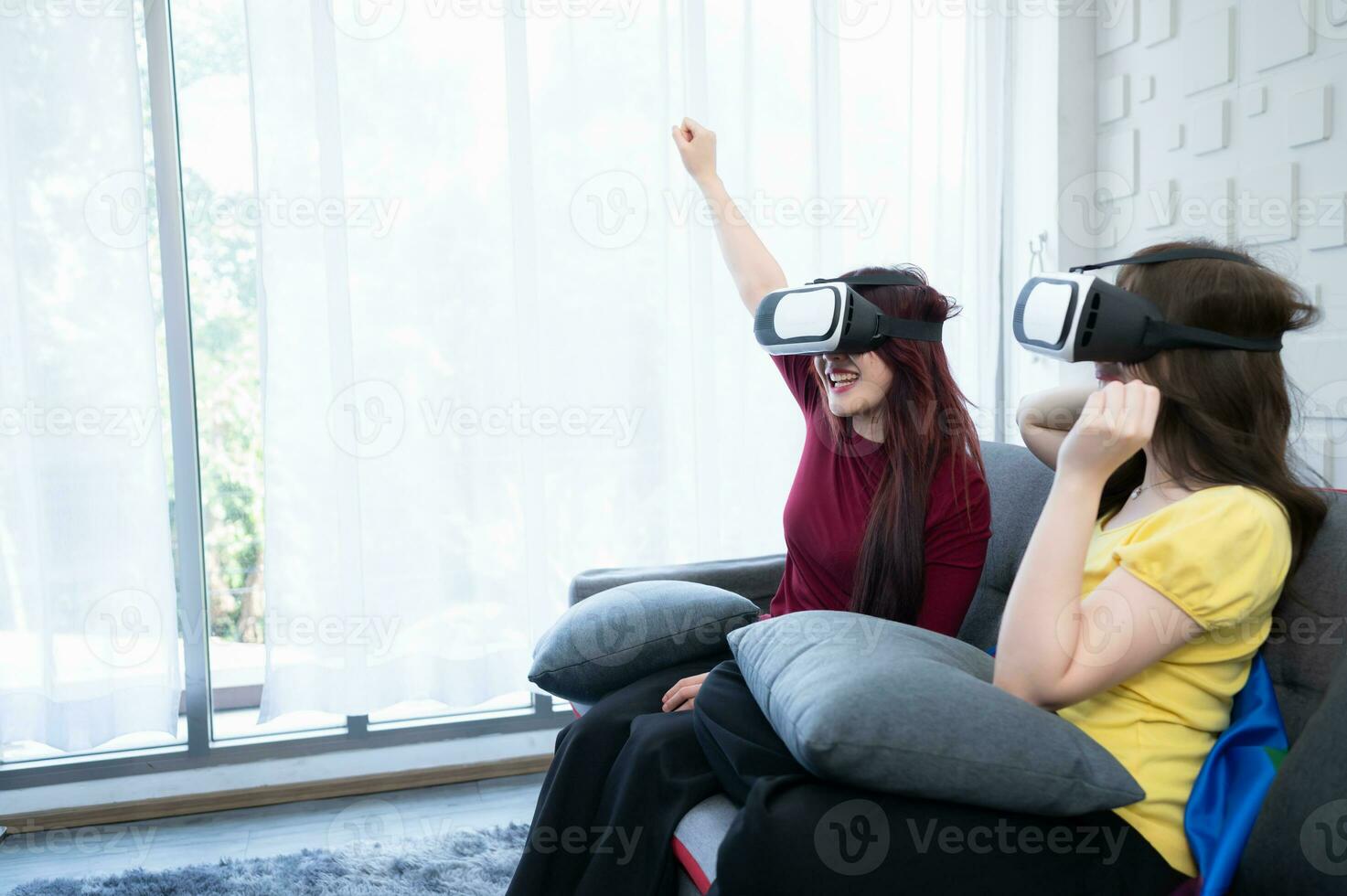 The LGBT couple in the house's living room enjoy a quiet weekend by playing games the virtual reality machine. photo