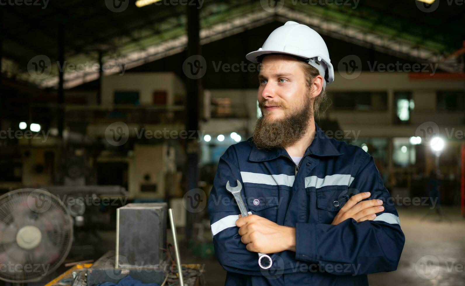 Portrait of mechanical engineers are checking the working condition of an old machine that has been used for some time. In a factory where natural light shines onto the workplace photo