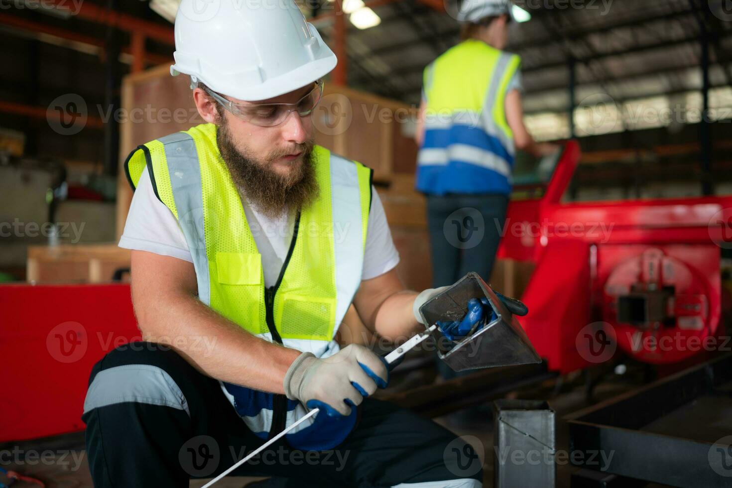 A mechanical engineer measuring product dimensions of new machinery installed photo