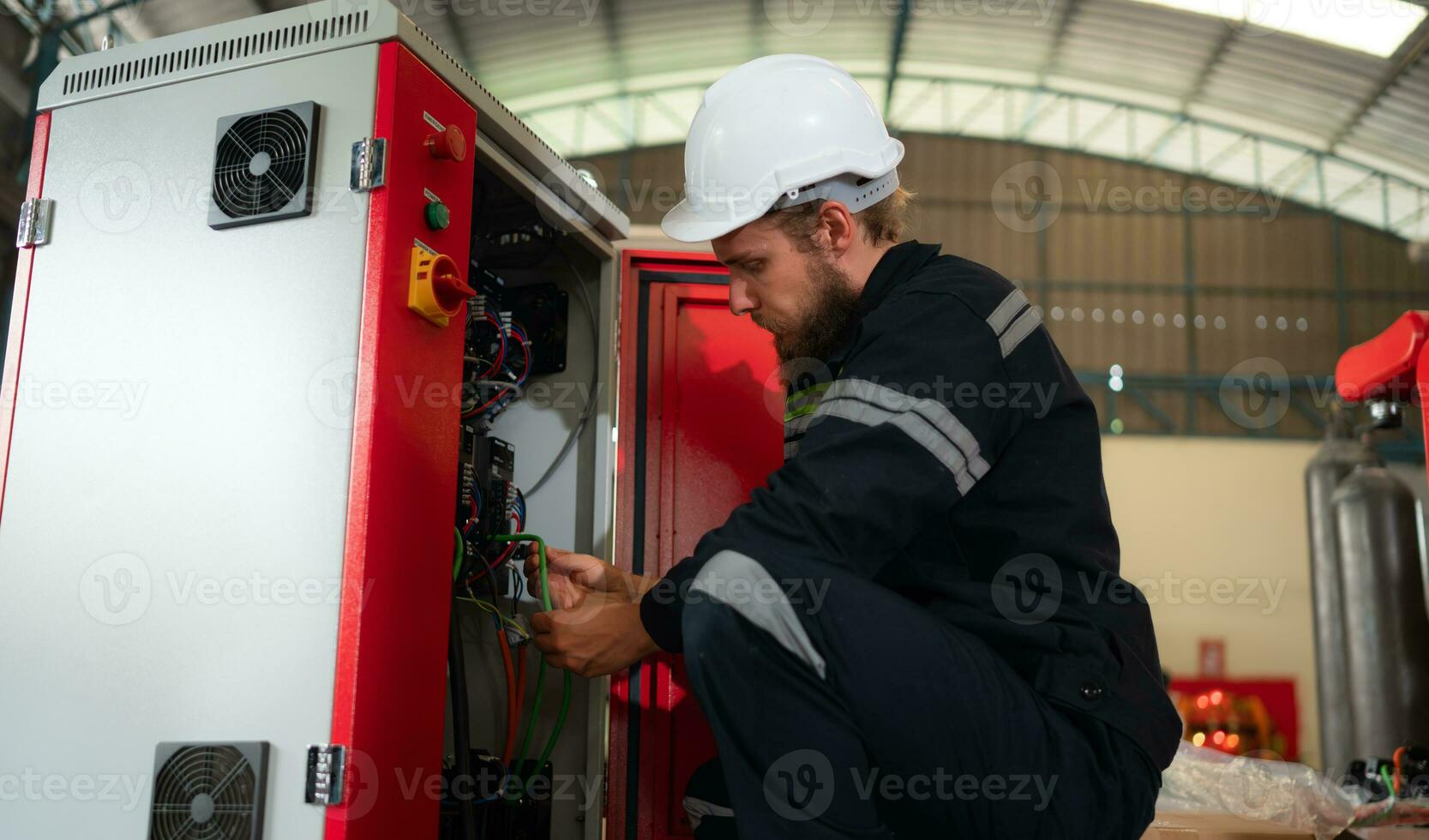 Electrical engineer with the mission of installing a robot arm electrical system photo