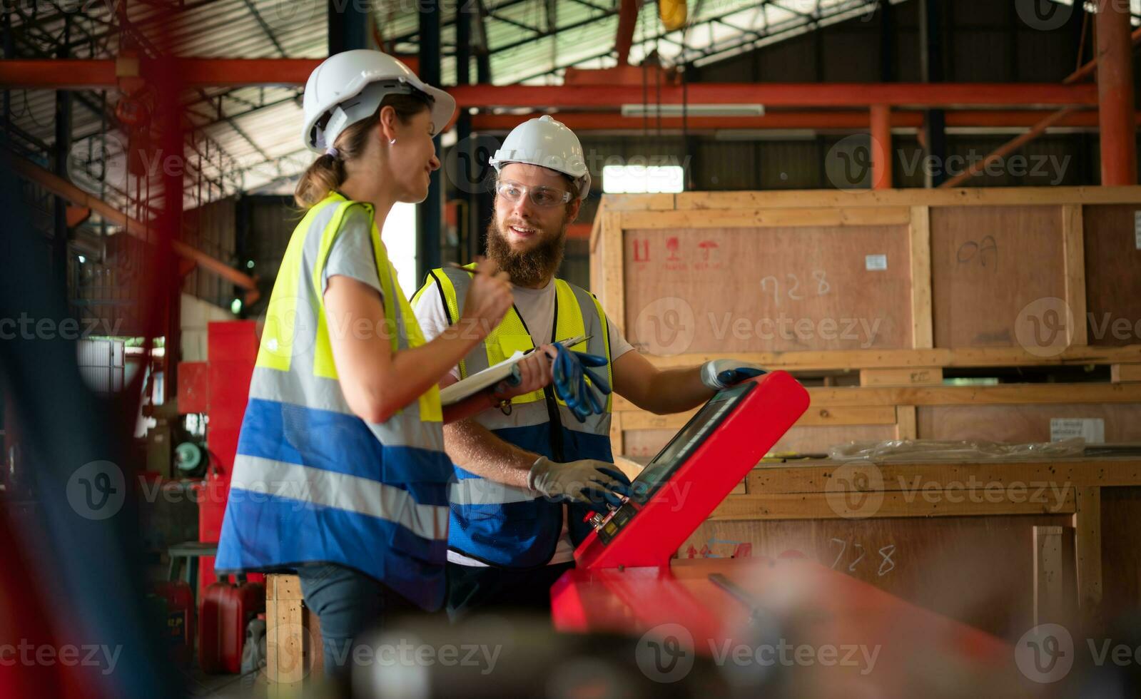 Both of mechanical engineers are checking the working condition of the new machine after completing the installation photo