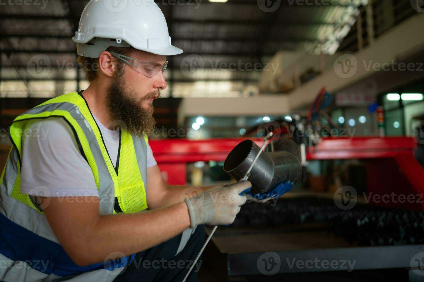 A mechanical engineer measuring product dimensions of new machinery installed photo