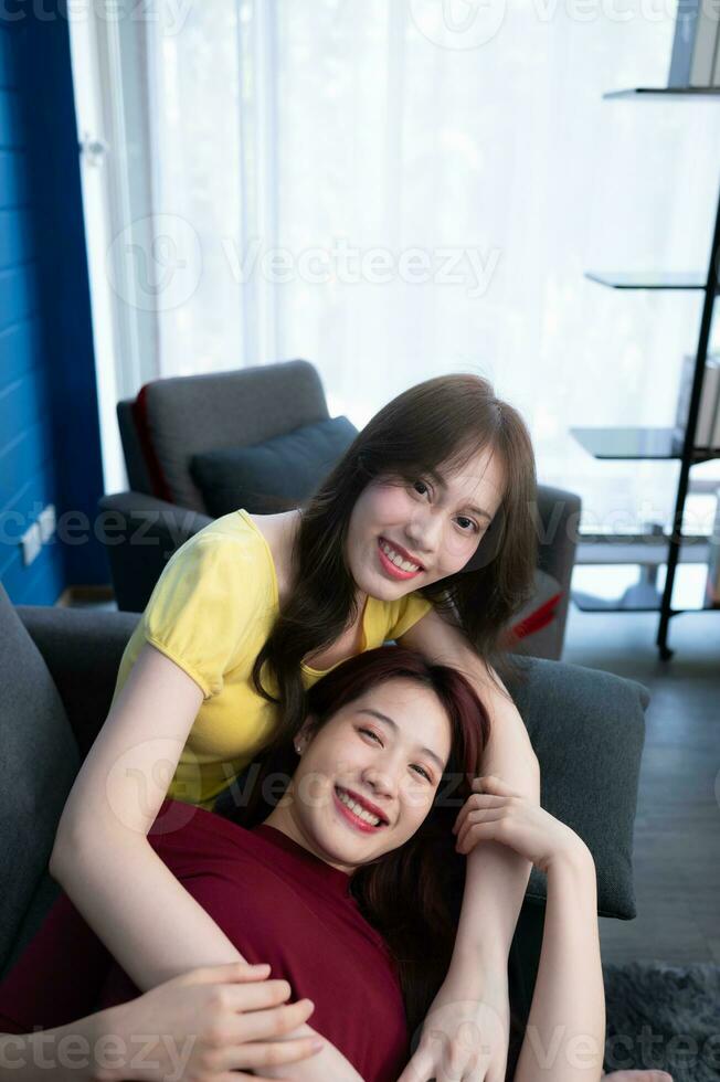 The LGBT couple with vacation activities at home such as chats, teasing, talking, watching movies, listening to music in a happy mood. photo