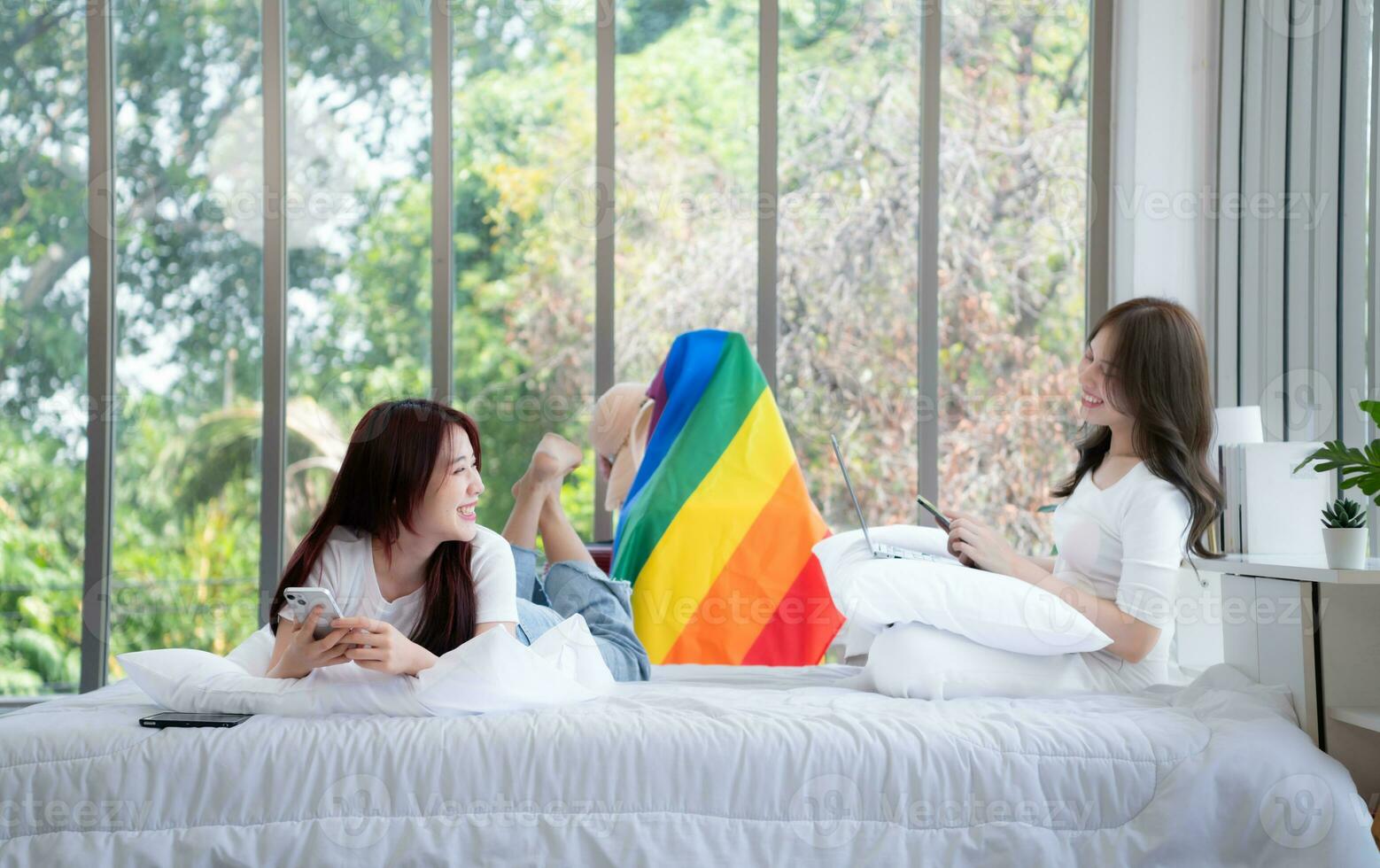 When an LGBT couple arrives in their hotel room they lie down Relax and chat with friends before going out to travel photo