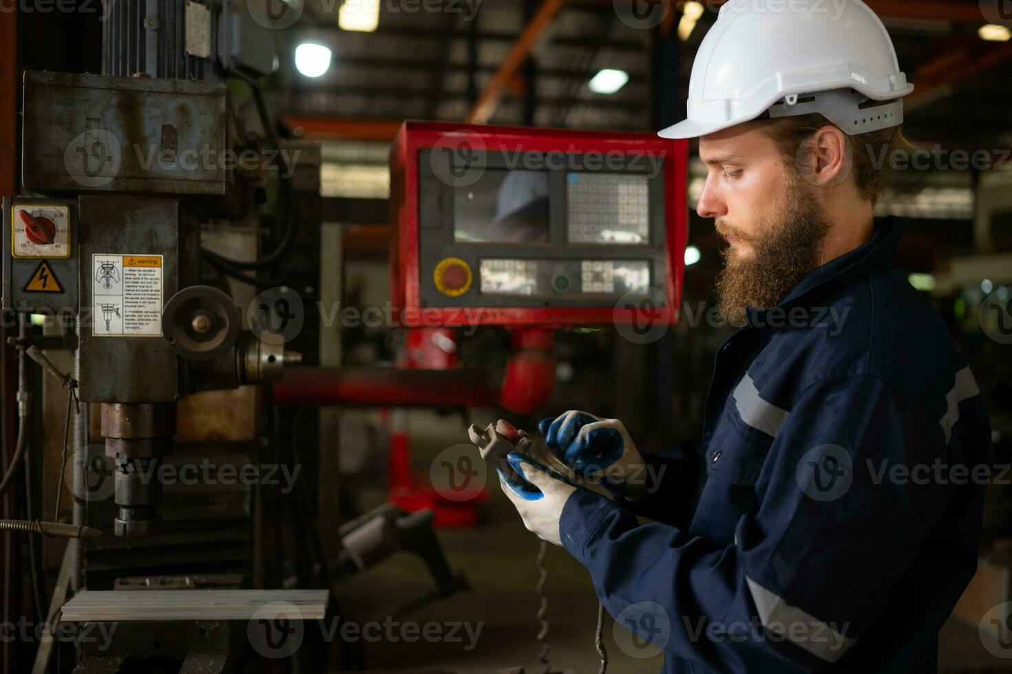 Portrait of mechanical engineers are checking the working condition of an old machine that has been used for some time. In a factory where natural light shines onto the workplace photo