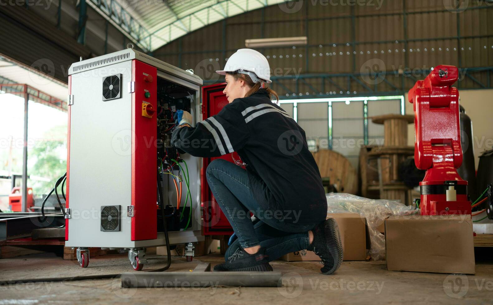 Electrical engineer with the mission of installing a robot arm electrical system photo