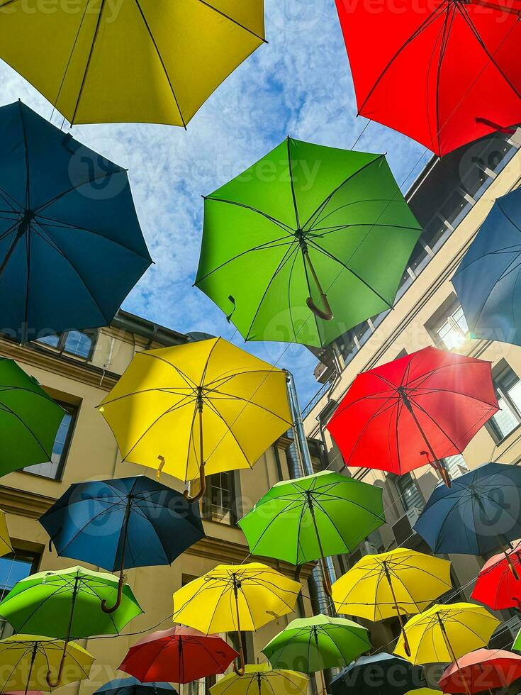 Colorful umbrellas float in the sky and decorate the street photo