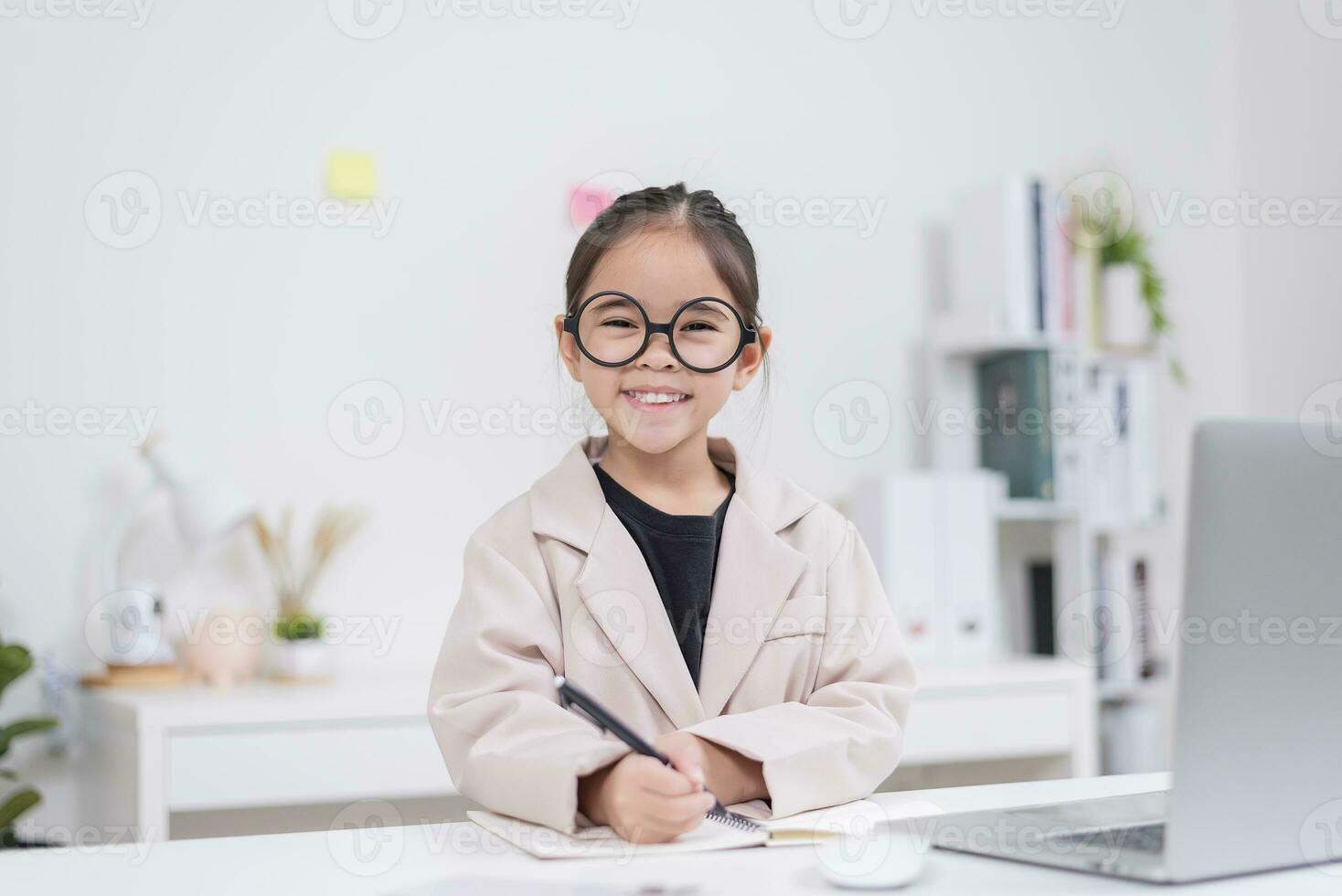 Little business lady Asia. formalwear sitting at the table and using laptop photo