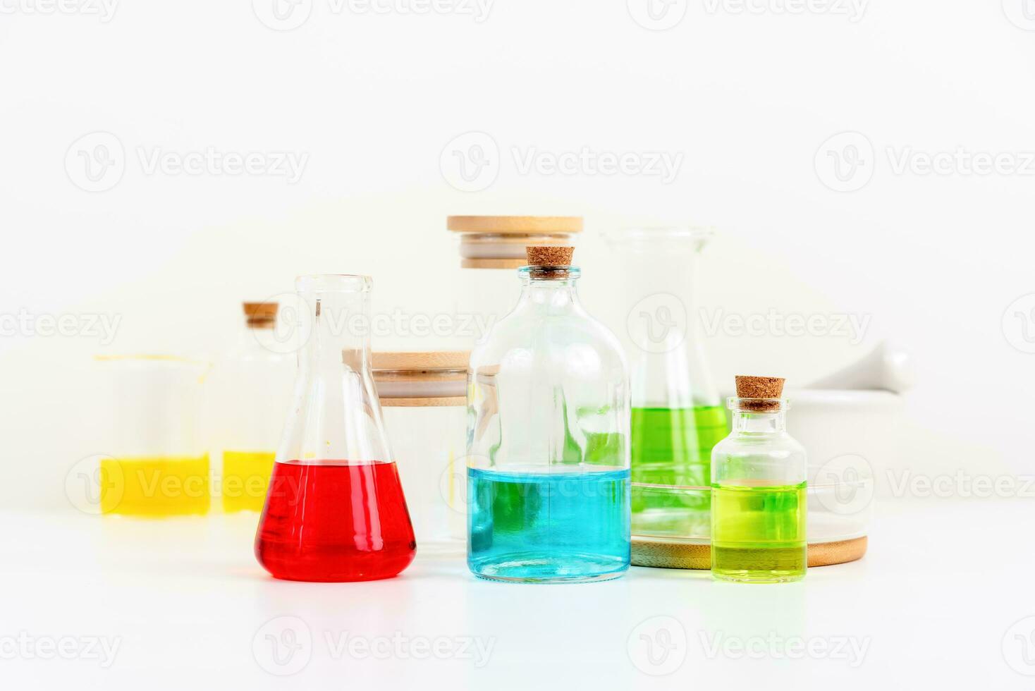 some test tube on the white table with beakers, flasks, and test tubes filled with colorful liquids photo