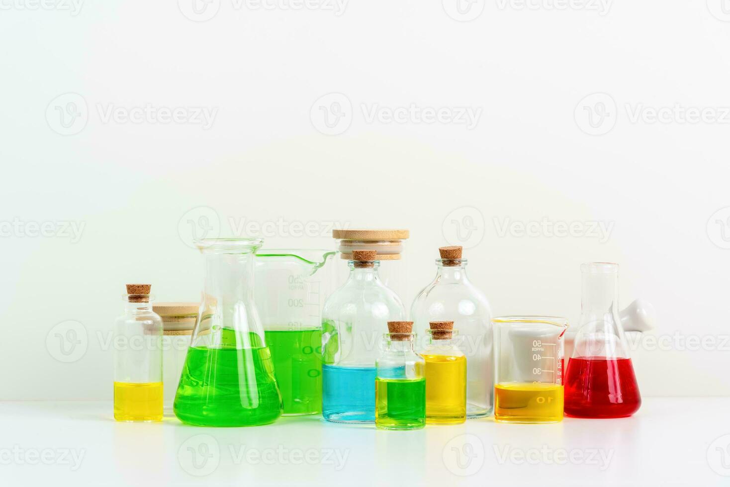 some test tube on the white table with beakers, flasks, and test tubes filled with colorful liquids photo