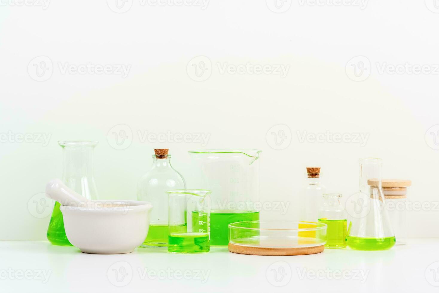 some test tube on the white table with beakers, flasks, and test tubes filled with colorful liquids photo