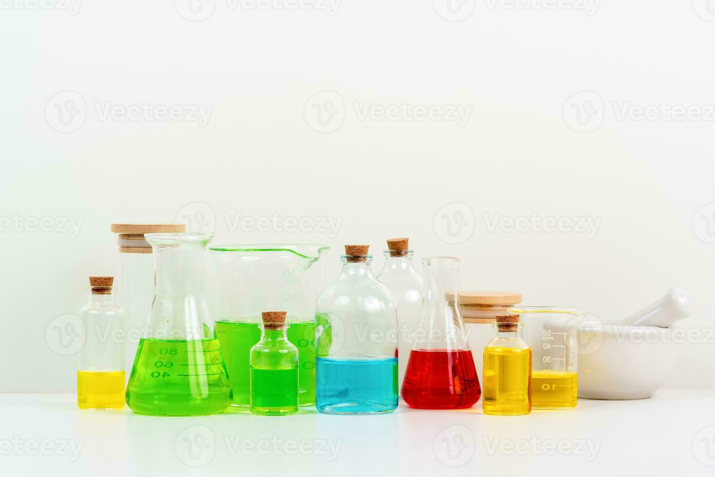 some test tube on the white table with beakers, flasks, and test tubes filled with colorful liquids photo