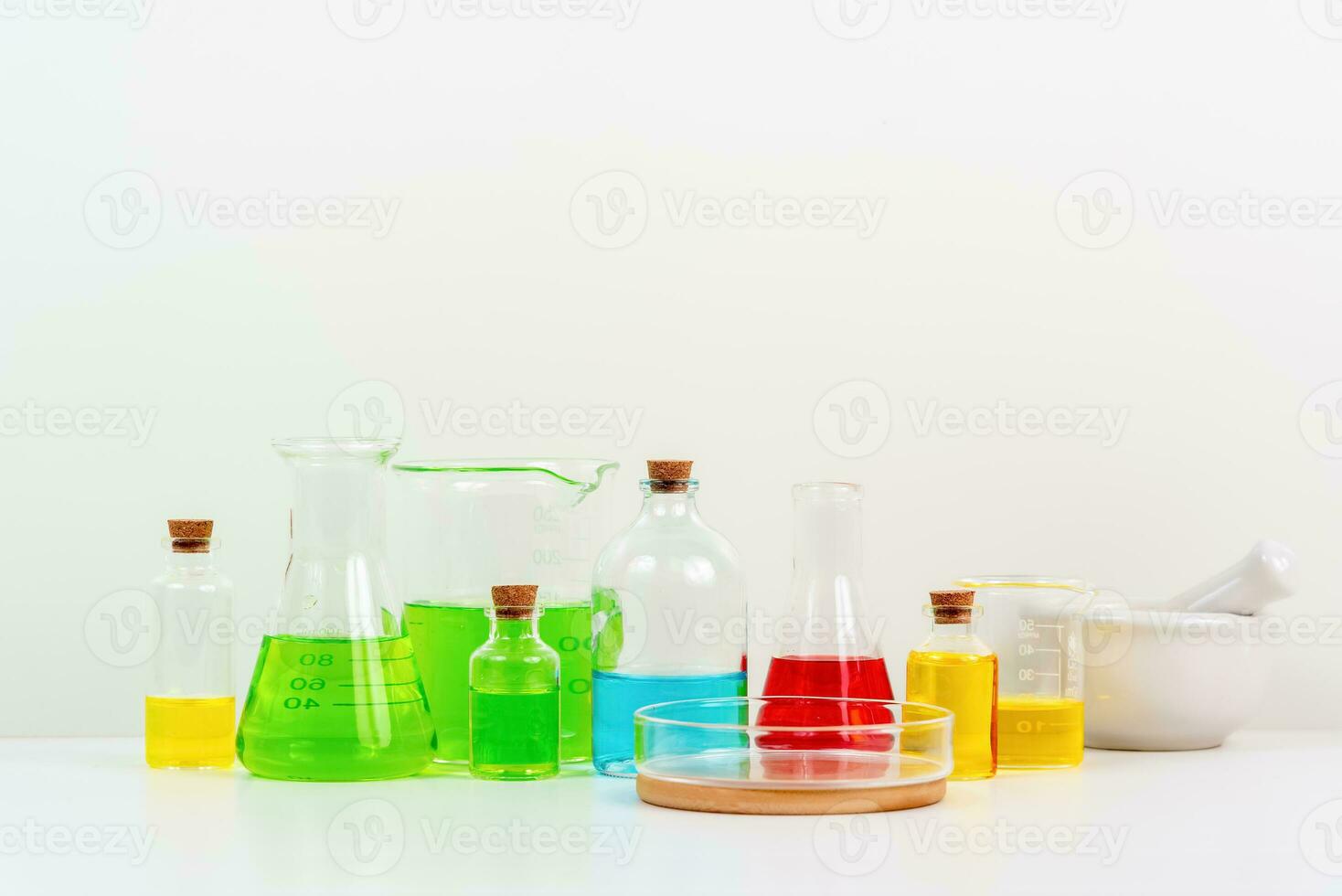 some test tube on the white table with beakers, flasks, and test tubes filled with colorful liquids photo