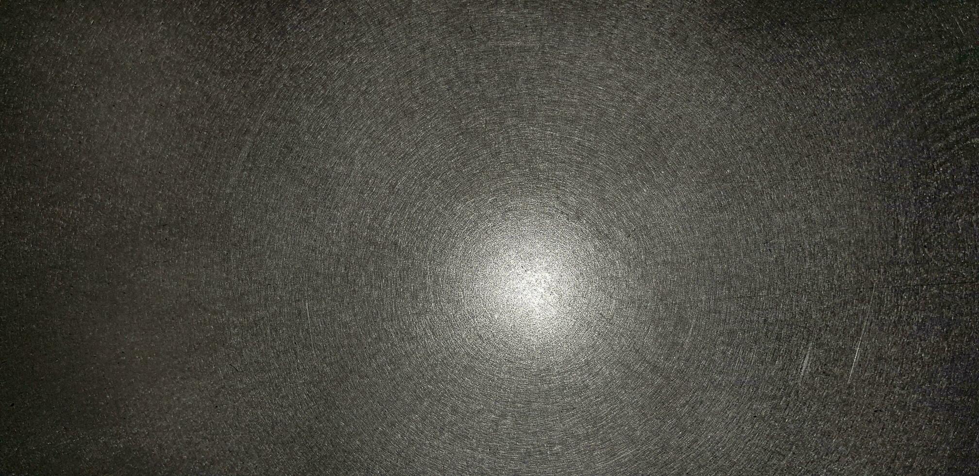 Lighting shining on black background and reflection. Abstract light on stainless steel floor. photo
