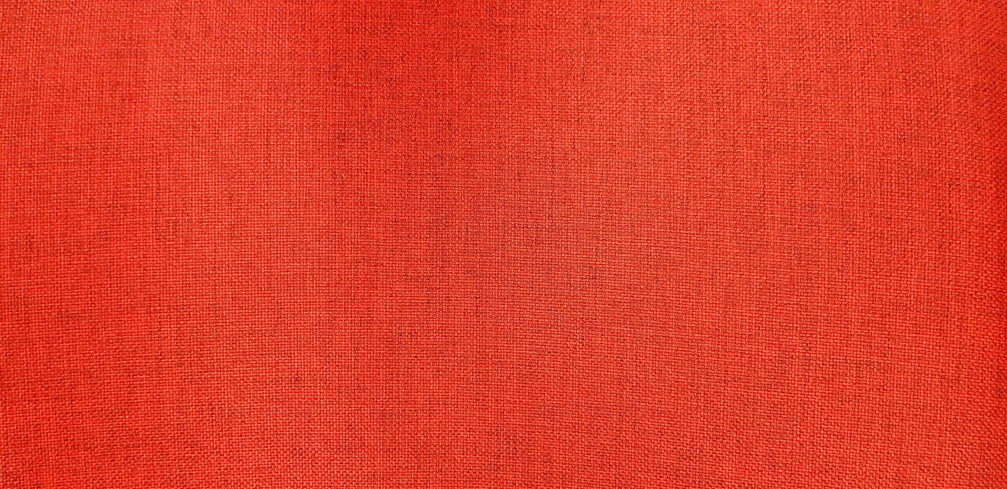 Red leather cotton or fabric chair for background. Close up surface of material and Textured wallpaper. photo