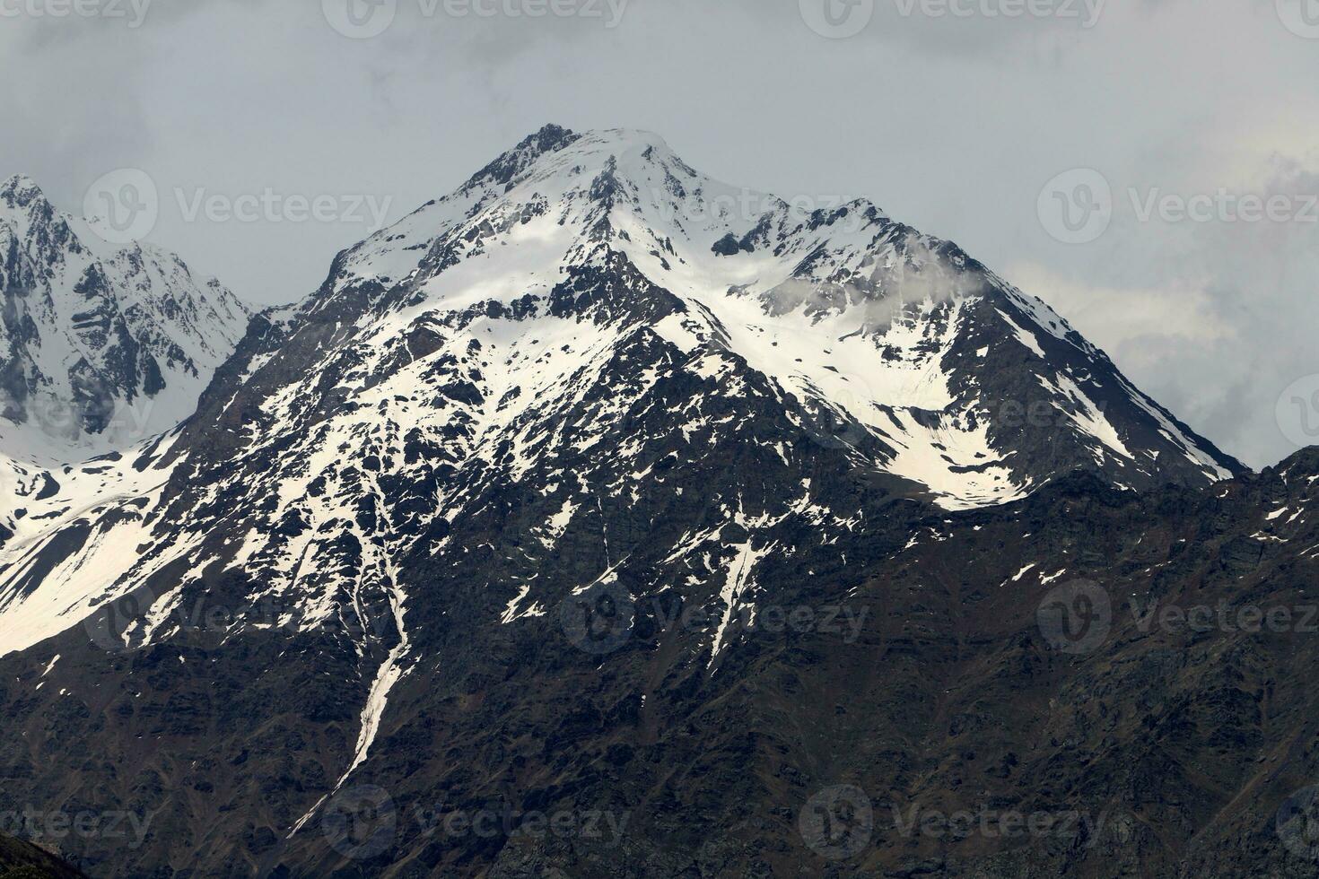 Snow-covered mountain peaks of the Main Caucasian Range. Landscape in the mountains of Georgia. photo