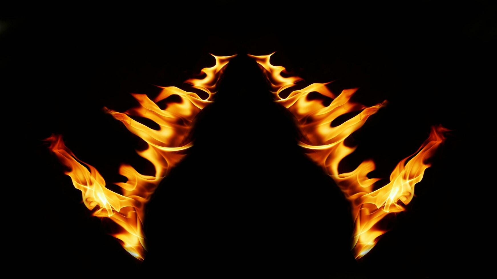 A beautiful flame shaped as imagined. like from hell, showing a dangerous and fiery fervor, black background. photo