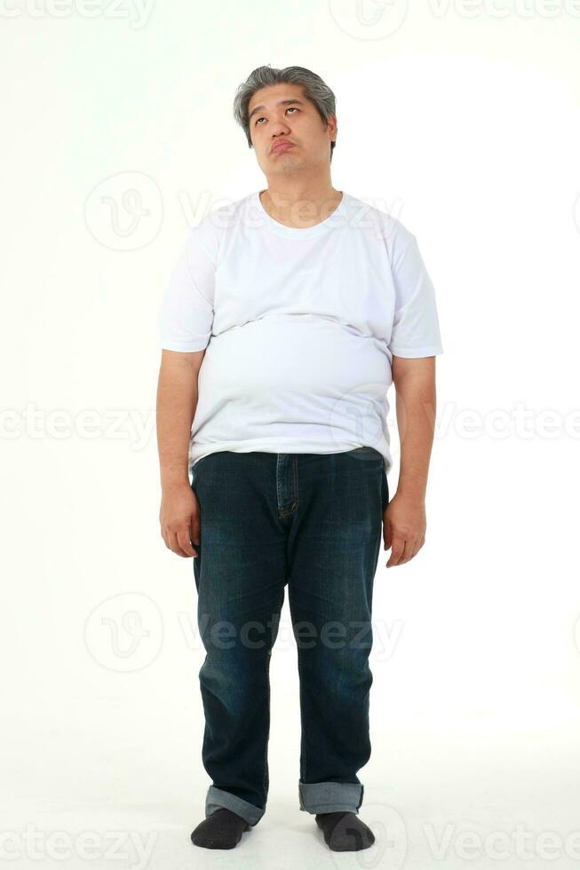 fat man wearing white shirt standing on a white background He felt stressed. weight loss concepts, health problems of obese people photo