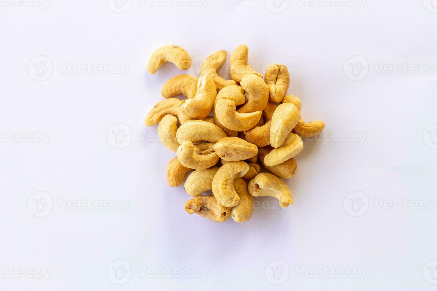 Many Roasted salted cashew nuts  isolated on a white background photo