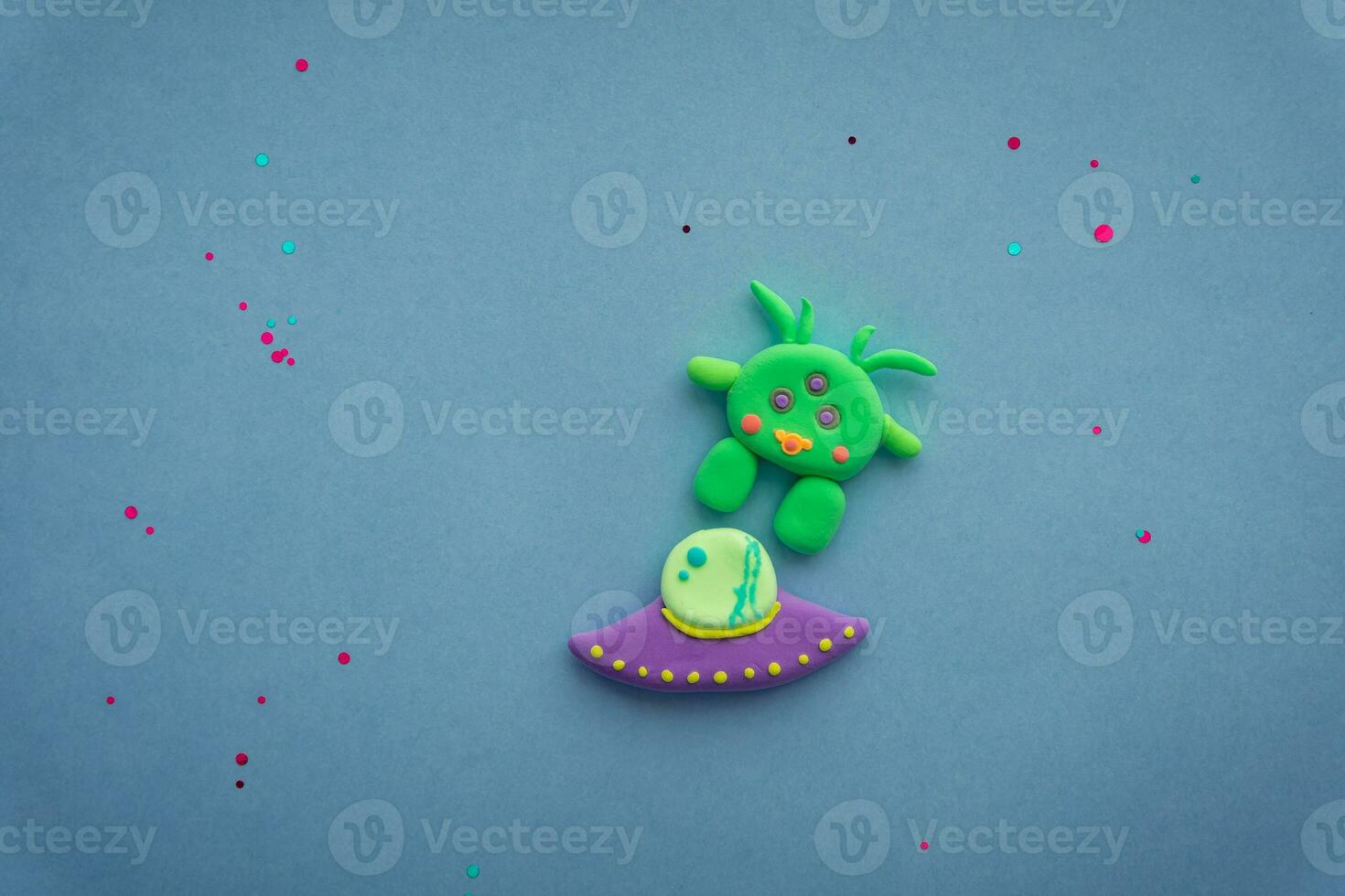 Plasticine 3D UFO, spaceship sculpture, cute green alien on starry background photo