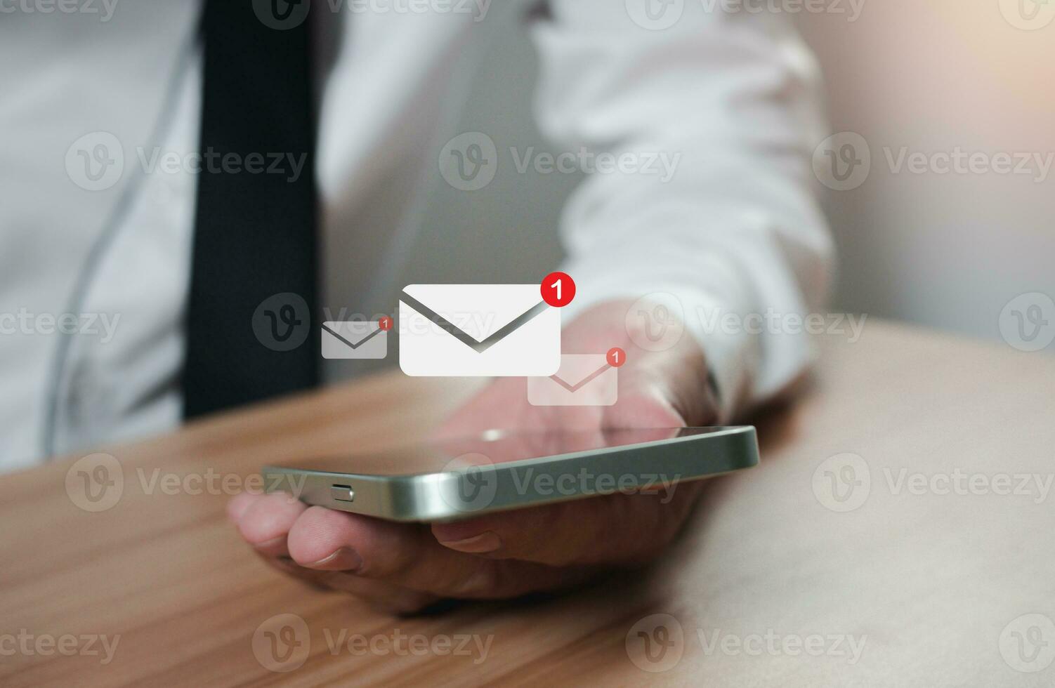 businessman holding a phone along with the e-mail icon. New email notification ideas for business email communication and digital marketing. The inbox receives electronic message notifications. photo