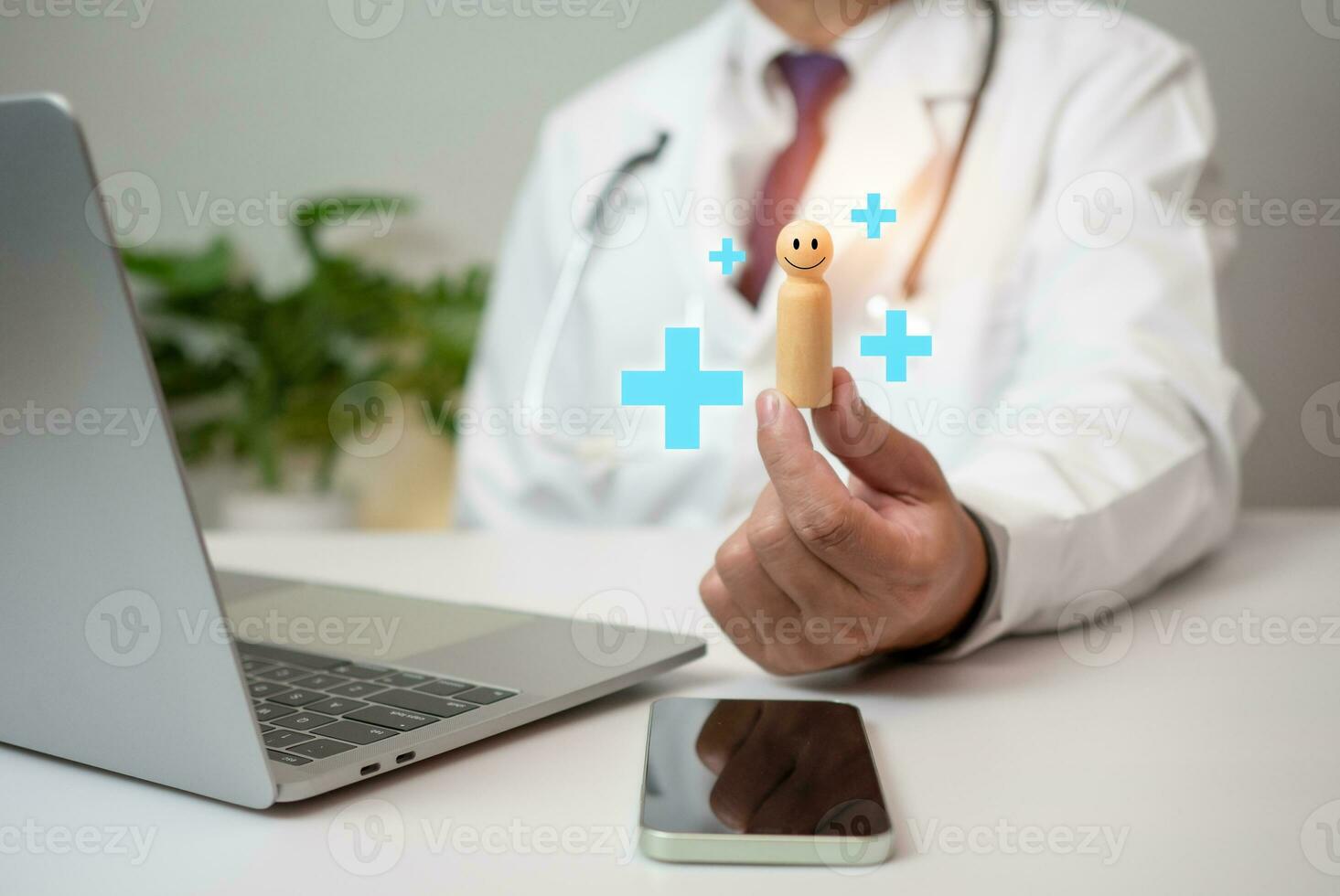 Doctor holding wood doll and plus sign at hospital office. Medical health care and medical services. photo