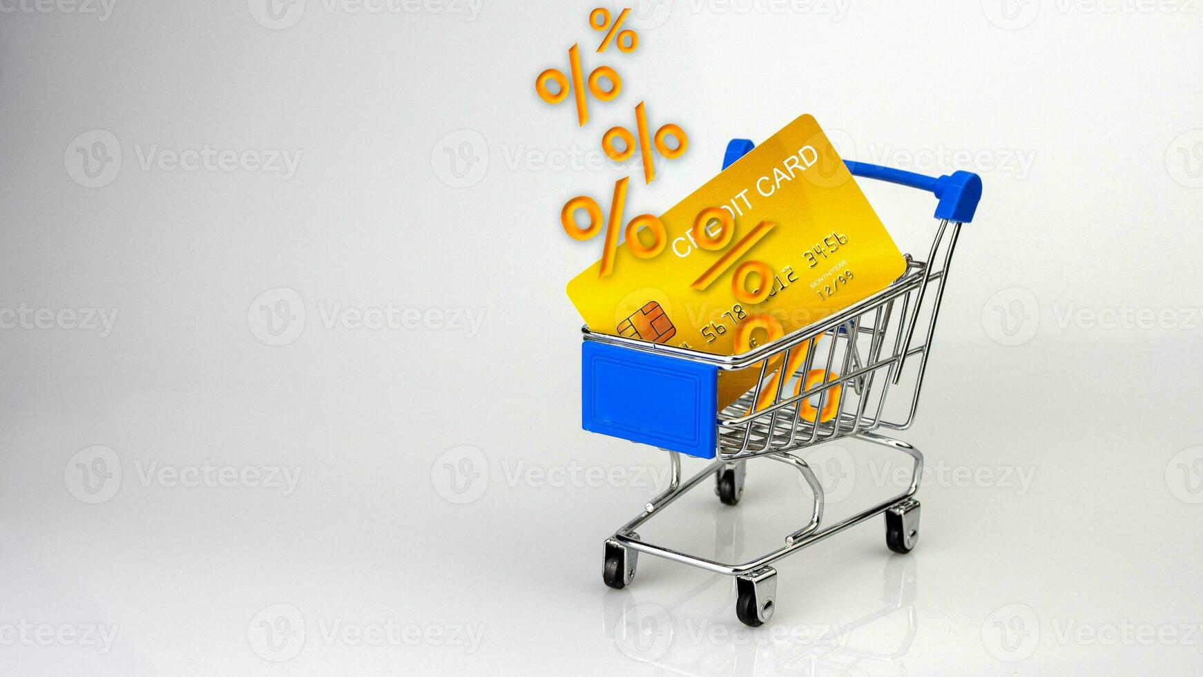 Sale percentage falling in shopping cart and credit card on white background. sale concept. shopping concept. photo