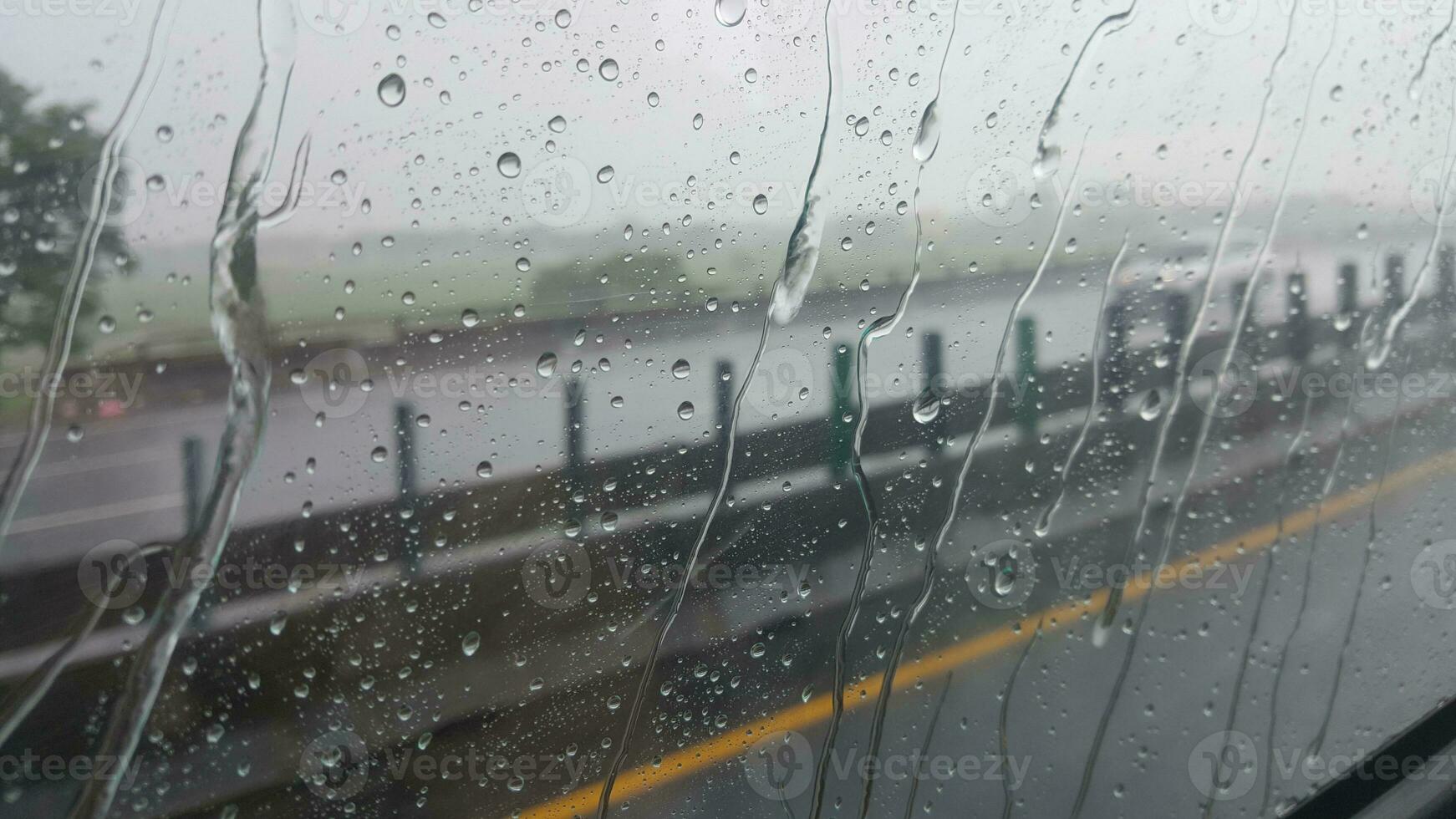 Sitting in the car to enjoy the water droplets on the glass photo